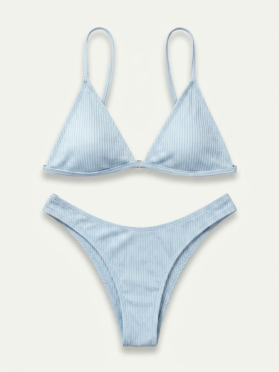 A two-piece light blue ribbed bikini set with a triangle top and matching high-cut bottoms, laid flat on a light cream background.