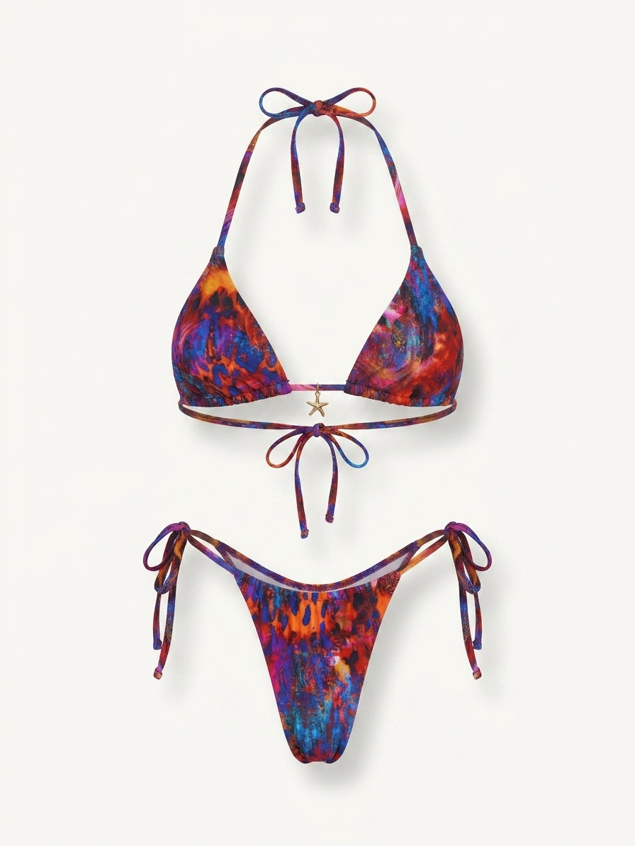 A two-piece string bikini set with a vibrant, multicolored abstract tie-dye pattern in shades of blue, purple, red, and orange, displayed on a clean off-white background.