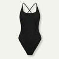 A black ribbed knit one-piece swimsuit with thin crisscross shoulder straps, shown flat against a light off-white background.
